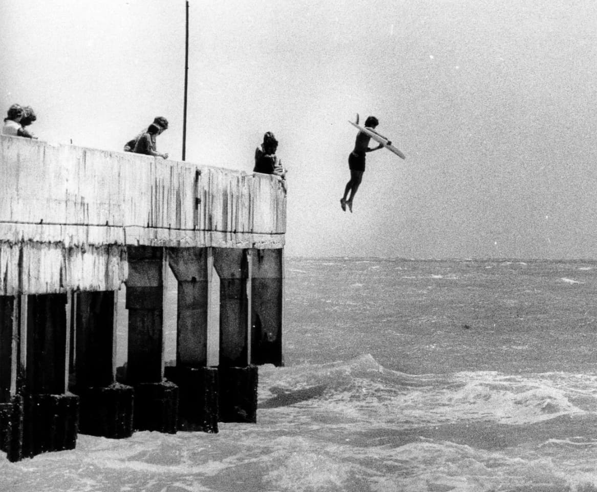 A surfer jumps into the Atlantic Ocean, 1979. 